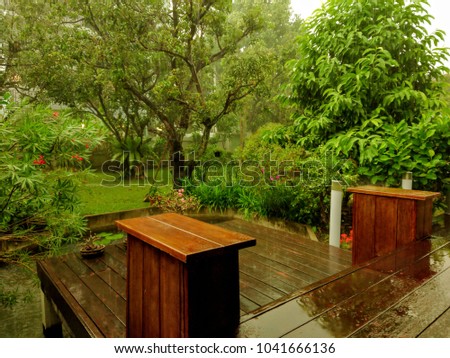 Patio and a garden in the tropical rain thai visible as blur view in a foreground