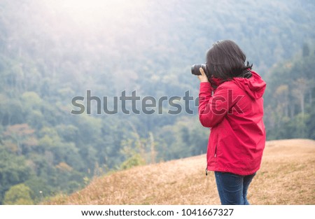 Young woman photographer take forest picture, travel concept
