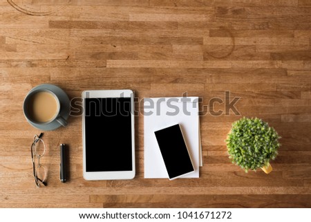 smartphone and tablet on wooden desk with nobody
