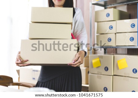asian beautiful girl hold cardboard package for sale to shopping online