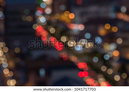 Abstract blur bokeh image of light from  vehicle and the light bulb on a city street in the traffic jam , can use wallpaper or background use