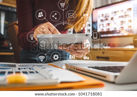  businesswoman hand working with laptop computer, tablet and smart phone in modern office with virtual icon diagram at modernoffice in morning light  Royalty-Free Stock Photo #1041718081