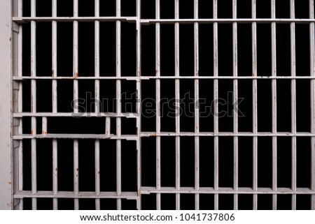 Prison cell bars with black background Royalty-Free Stock Photo #1041737806