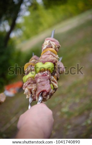 Raw meat, sliced apples and potatoes  on skewers