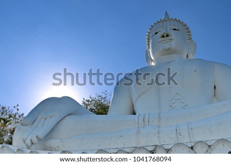 A big white Buddha and the blue sky in Thailand.