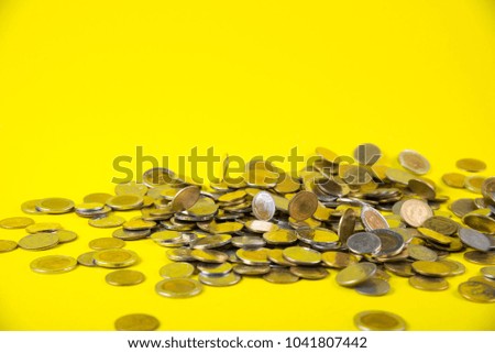 Falling coins money on yellow background, business wealth concept idea.