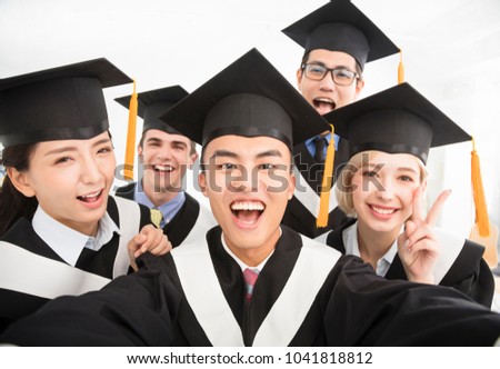 happy graduates making selfie photo in classroom
