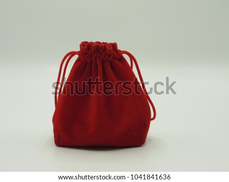 Red velvet bag is used to bring jewelry to loved ones, special in the day.white background  cloced up