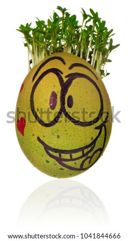 Hand painted easter egg in a funny smiley guy face and colored green with red hearts and cress like hair. The watercress stylized for the hairstyle of the character. Egg in green , red on a white back