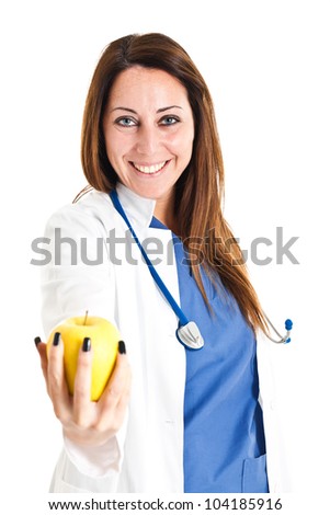 Female doctor offering a yellow apple