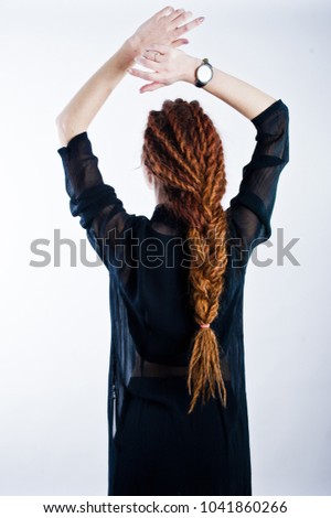 Studio shoot of back girl with dreads on white background.