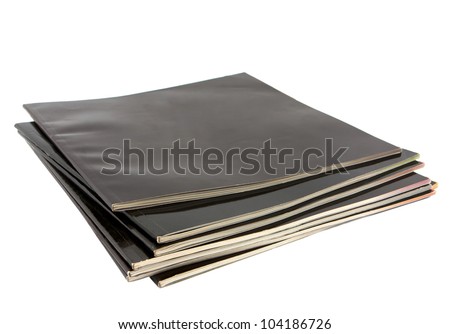 Stack of black covered magazines isolated on white