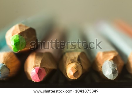 Macro photography  of colored pencils. Blurred perspective. Mechanical sharpening of pencils. Photo for the site about art, hobbies, education.