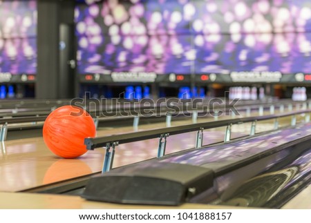 bowling ball rolls in between of the bumper rails, certain to hit target