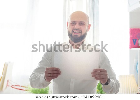 man holding a blank of paper. soft focus