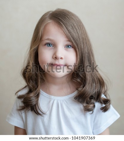 Portrait of a beautiful little thoughtful girl. Girl look sad. Child close up