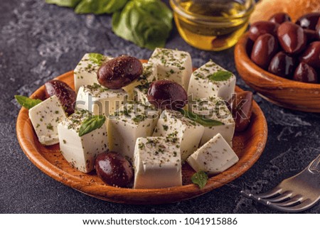 Greek cheese feta with oregano and olives, selective focus.