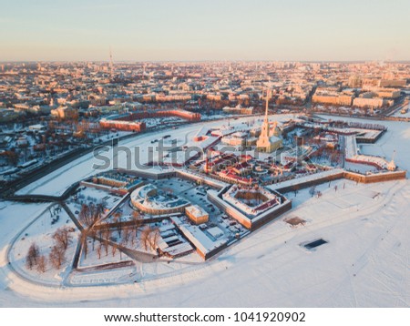 Beautiful aerial winter sunny view of Saint-Petersburg, Russia, Peter and Paul Fortress with cityscape and scenery beyond the city, shot from drone
