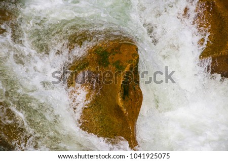 Rocks in stream flowing water