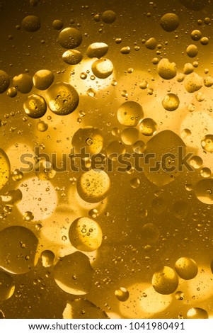 Gold abstract background with bubbles made with oil abd water. Lava lamp effect.