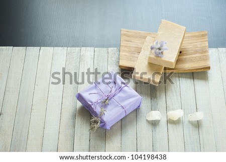 soaps stack and flowers on wooden table
