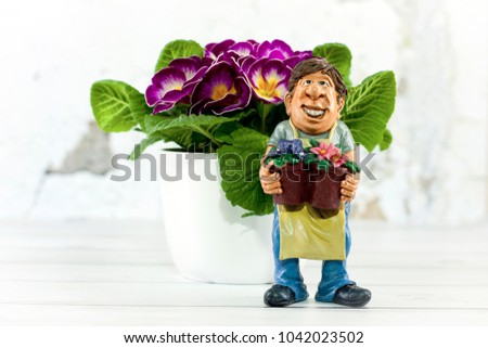 Funny work shape – gardener figure with a flower