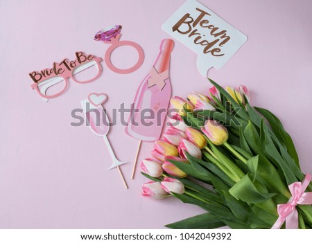 on a pink background pink tulips and pictures for a hen party