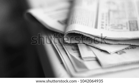 Newspapers on horizontal surface, daily papers with news. Selective focus, side view