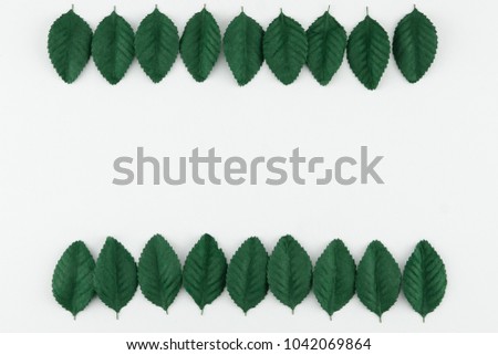 Green paper leaves on white background with copy space