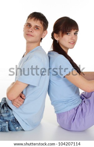 A good pair of Caucasian boy and girl sitting on a white background