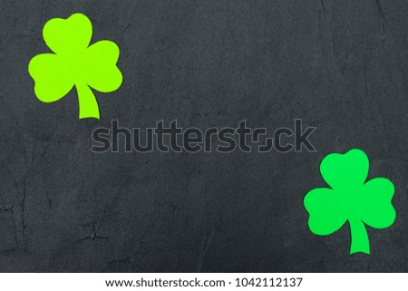 St. Patrick's Day theme colorful horizontal banner. Green shamrock leaves with copy space on black background. Felt craft elements for greeting card.