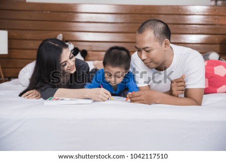 portrait of Cheerful family playing together on bed