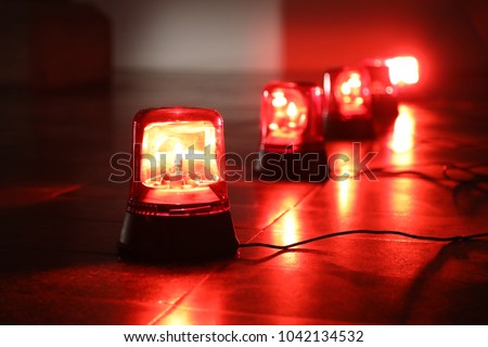 Background with big red flashing alarm lights. Royalty-Free Stock Photo #1042134532