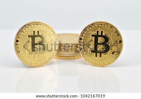 Gold Bitcoins on white background. Selective focus.