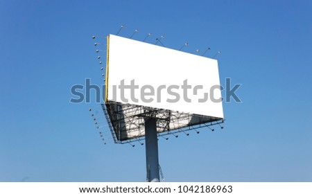 Blank outdoor billboard. Blank banner outdoor with the grass. Outdoor billboard on the blue sky.