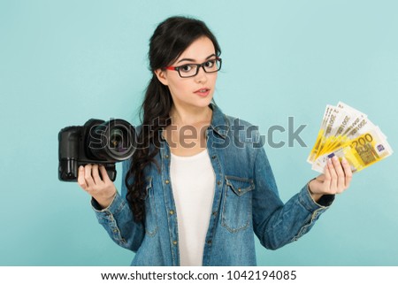 Young woman with camera and cash