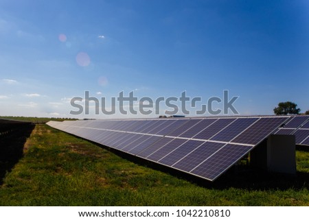 Solar panels in rows, the sun shines from the sky
