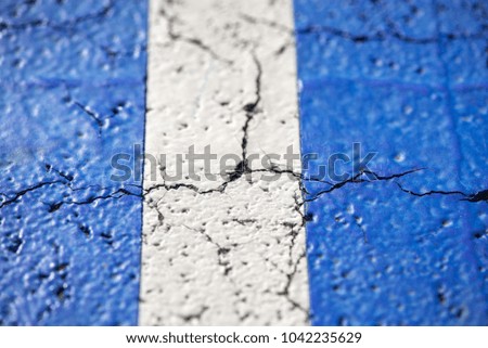 Abstract, blue background of newly made outdoor basketball court in park. Visible asphalt texture, freshly painted lines