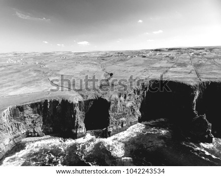black and white landscape photograph from the cliffs of moher in county clare, ireland