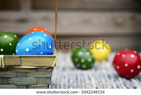  Holiday,event and Easter concept-hand-painted Easter eggs in a basket on a wooden background.