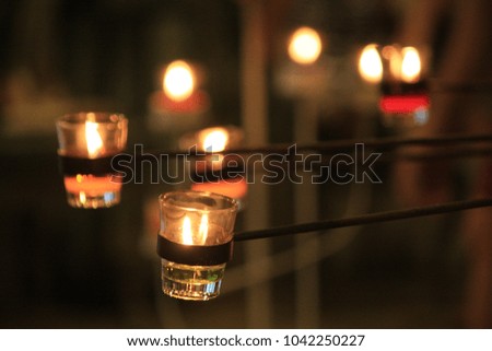 Lighting candles in the glass. 