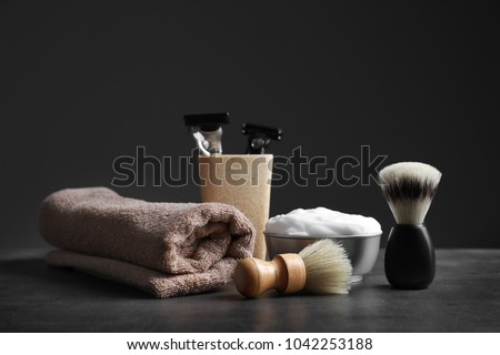 Shaving accessories for man on table against dark background Royalty-Free Stock Photo #1042253188