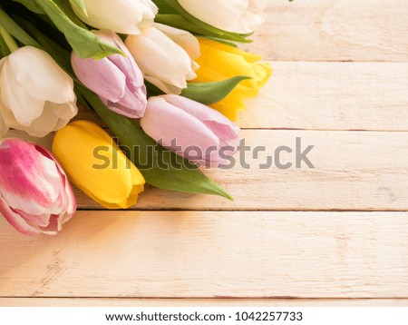 Bouquet of colorful tulips on wooden background