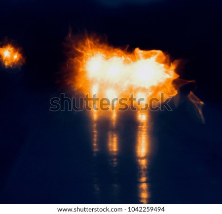 Illuminated vehicles lights on the road unique stock photograph