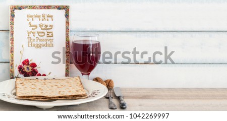 Pack of matzah or matza, Passover Haggadah, red kosher wine and white passover seder plate on a vintage wood background with copy space.Hebrew text translation: The story of Passover

 Royalty-Free Stock Photo #1042269997