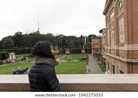 Horizontal picture of woman looking at the Vatican Museum in Rome, Italy