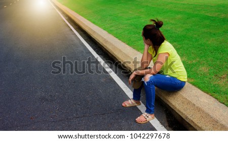 Picture Asian girl Sit waiting car roadside in public park