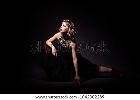 Portrait of beautiful fit young ballerina girl in casual and black casual and ballet clothes posing in studio
