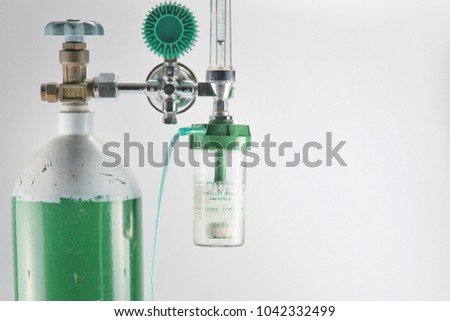 Equipment medical Oxygen tank and Cylinder Regulator gauge.Control pressure oxygen gas for care a patient respiratory disease and emergency CPR at Hospital, Close up focus on white background. Royalty-Free Stock Photo #1042332499