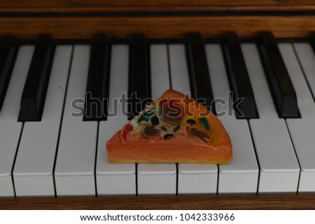 Pizza slice on piano.